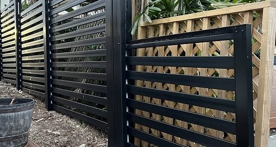 Black semi-privacy horizontal-slat aluminum fence installation in Southeast Florida