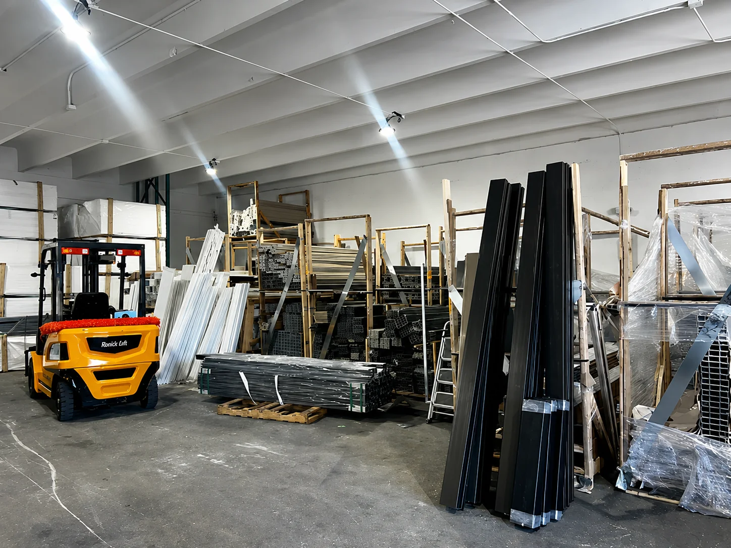 Elite PVC Miami warehouse with forklift loading PVC fence inventory - Southeast Florida fence supplier